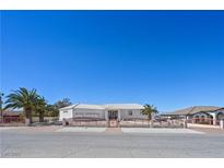 Charming single-story home featuring a gated entry, desert landscaping and a spacious two car garage at 736 N Kiel St, Henderson, NV 89015