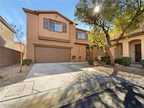 Charming home featuring a two-car garage and a well-maintained front yard with beautiful landscaping at 8962 Rufina St, Las Vegas, NV 89148