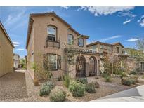 Charming two-story home with a gated front porch and desert landscaping at 1111 Frye Mesa Ave, North Las Vegas, NV 89086