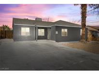 Charming single-story home featuring a gray exterior, well-maintained yard, and an extended driveway at 1417 Joshua Way, Las Vegas, NV 89101