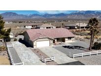 Inviting single-story home with well-maintained landscaping and mountain views at 2080 Mount Charleston Dr, Pahrump, NV 89048