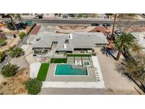 Stunning aerial view of backyard pool area with manicured lawn, spa, mature trees, and patio seating at 2711 Ashby Ave, Las Vegas, NV 89102