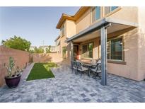 Beautiful backyard with a covered patio and an outdoor seating area, perfect for entertaining at 3034 Scenic Rhyme Ave, Henderson, NV 89044