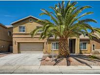 Two-story home featuring a front yard with desert landscaping and a large palm tree at 3516 Bryan Keith Ave, North Las Vegas, NV 89031