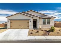 Charming single-story home featuring a beige facade, landscaped front yard, and a two-car garage at 3862 E Summit Ave, Pahrump, NV 89061