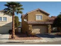 Charming two-story home featuring a two-car garage, desert landscaping, and classic architectural details at 4446 Scarlet Sea Ave, North Las Vegas, NV 89031