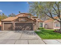 Charming single-story home with a three car garage and a well-manicured lawn at 4516 Whelk Pl, North Las Vegas, NV 89031