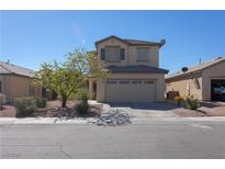 Two-story home featuring desert landscaping, neutral stucco, and a two-car garage, creating curb appeal at 53 Hoke Edward Ct, North Las Vegas, NV 89031