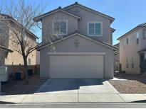 Traditional two-story home featuring a two-car garage and neutral-colored facade at 6425 W Haleh Ave, Las Vegas, NV 89141