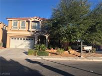 Charming two-story home featuring a well-maintained lawn, stucco exterior, and a two-car garage at 8494 Langhorne Creek St, Las Vegas, NV 89139