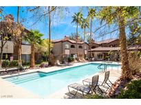 Beautiful community pool with lounge chairs and well-manicured landscaping on a sunny day at 9000 Las Vegas Blvd # 1029, Las Vegas, NV 89123