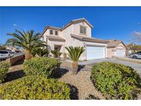 Two-story stucco home boasts a two-car garage, tile roof, and desert landscaping with palm trees and shrubs at 9678 Swaying Elms Ct, Las Vegas, NV 89147