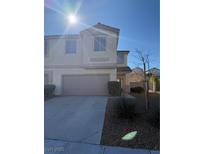 Well-maintained two-story home featuring a two-car garage and neutral stucco exterior at 1123 Scenic Crest Dr, Henderson, NV 89052