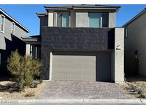 Modern two-story home featuring a two-car garage and brick paved driveway at 1586 Crowned Eagle St, Las Vegas, NV 89138