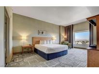 Comfortable bedroom featuring a king bed, city view, and modern decor at 211 E Flamingo Rd # 1707, Las Vegas, NV 89169