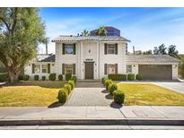 Charming two-story home with a meticulously landscaped yard and a well-maintained walkway at 2301 W El Camino Ave, Las Vegas, NV 89102