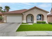 Charming single-story home with a well-manicured lawn, arched entryway, and a two-car garage at 3021 Scenic Valley Way, Henderson, NV 89052