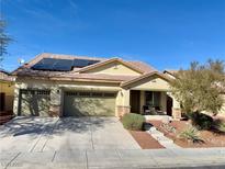 Charming single-story home with a three-car garage, desert landscaping, and solar panels in a well-maintained neighborhood at 4058 Helens Pouroff Ave, North Las Vegas, NV 89085