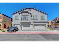 Charming townhome with a well-maintained exterior, garages, and a small balcony at 4640 Flower Moon Ave # 102, North Las Vegas, NV 89084