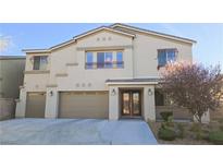 Charming two-story home featuring a three-car garage and a beautifully landscaped front yard at 8223 Saddleback Ledge Ave, Las Vegas, NV 89147