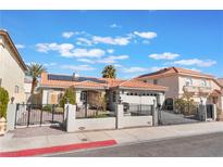 Attractive single-story home with a well-manicured lawn and wrought iron fencing at 8520 Copper Falls Ave, Las Vegas, NV 89129