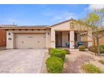 Charming single-story home with a two-car garage, desert landscaping and covered front porch at 1009 Via Canale Dr, Henderson, NV 89011