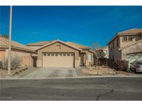 Inviting single story home features a two car garage and low maintenance desert landscaping at 204 Mchenry St, Las Vegas, NV 89144