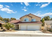 Charming two-story home with a well-manicured front yard and a two-car garage at 3012 Pier Harbor Dr, Las Vegas, NV 89117