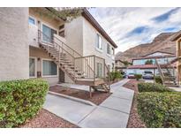 View of a two-story apartment building with beige siding and brown stairs at 3351 Indian Shadow St # 204, Las Vegas, NV 89129