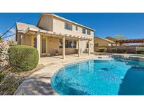 Inviting backyard pool with a covered patio and well-maintained landscaping for outdoor enjoyment at 3925 Champagne Wood Dr, North Las Vegas, NV 89031