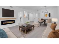 Bright living room featuring a fireplace, sleek gray floors, and a modern lighting fixture over a round dining table at 5155 W Tropicana Ave # 1052, Las Vegas, NV 89103