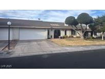 Charming single story home with a two car garage, a well-manicured lawn and mature landscaping at 5716 Ridgeline Ave, Las Vegas, NV 89107