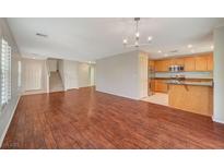 Spacious living room featuring hardwood floors, modern lighting, and open floorplan at 6424 Bombax Ct, Las Vegas, NV 89141