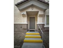 Inviting front entrance with unit number, leading to a gray door and charming steps to your future home at 6493 Za Zu Pitts Ave # 101, Las Vegas, NV 89122