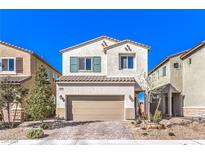Charming two-story home with a well-manicured lawn and an attached two-car garage with a brick paved drive at 6637 Rockhouse St, North Las Vegas, NV 89086