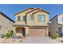 Two-story home featuring stucco exterior, a two-car garage, desert landscaping, and a charming covered entryway at 6806 Chargehand Ave, Las Vegas, NV 89156