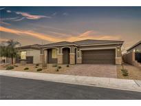 Charming single-story home with desert landscaping and a spacious two-car garage at 71 Gosia Grove Ave, North Las Vegas, NV 89031