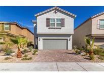 Charming two-story home with a brick driveway and desert landscaping at 8446 Vacarez Dr, Las Vegas, NV 89149