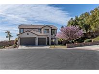 Two-story home with a three-car garage and lush landscaping at 10491 Williamville Ct, Las Vegas, NV 89129