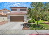 Charming two-story home featuring a well-maintained lawn and a two-car garage at 10218 Maltese Cross Ct, Las Vegas, NV 89183
