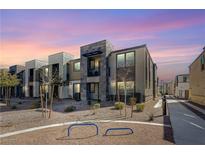 Beautiful modern townhome exterior featuring unique architecture with stone accents under a vibrant sunset at 1135 Tektite Ave, Henderson, NV 89011
