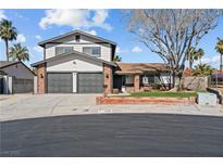 Charming two-story home featuring a well-manicured lawn, two-car garage, and mature trees at 3730 Grandview Pl, Las Vegas, NV 89120