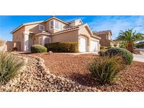 Charming home featuring a desert landscape, two-car garage, and well-maintained lawn at 4822 Van Carol Dr, Las Vegas, NV 89147