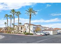 Beautiful building with tiled roof, palm trees, and manicured landscaping under bright blue skies at 50 Aura De Blanco St # 18201, Henderson, NV 89074