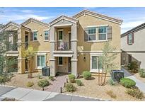 Inviting two-story townhome with desert landscaping and a covered entry at 668 Vetiver Ln, Henderson, NV 89015
