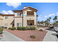 Inviting two-story condo featuring desert landscaping, a private balcony, and convenient stairwell access at 8501 W University Ave # 1002, Las Vegas, NV 89147