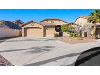 Charming single story home with a circular driveway, mature desert landscaping and a 3-car garage at 9732 Windom Point Ave, Las Vegas, NV 89129