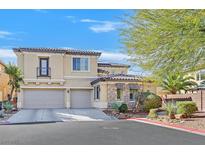Inviting two-story home features a two-car garage, a balcony and charming stone accents at 10001 Blairwood Ct, Las Vegas, NV 89178