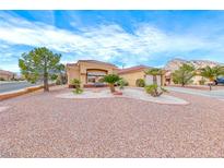 Inviting single-story home featuring a desert landscape, red tile roof, and a neutral-toned exterior at 10917 Mcneese Ct, Las Vegas, NV 89134