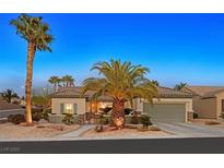 Charming single-story home with a desert landscape, palm trees, and a cozy two-car garage at 2054 Wildwood Lake St, Henderson, NV 89052